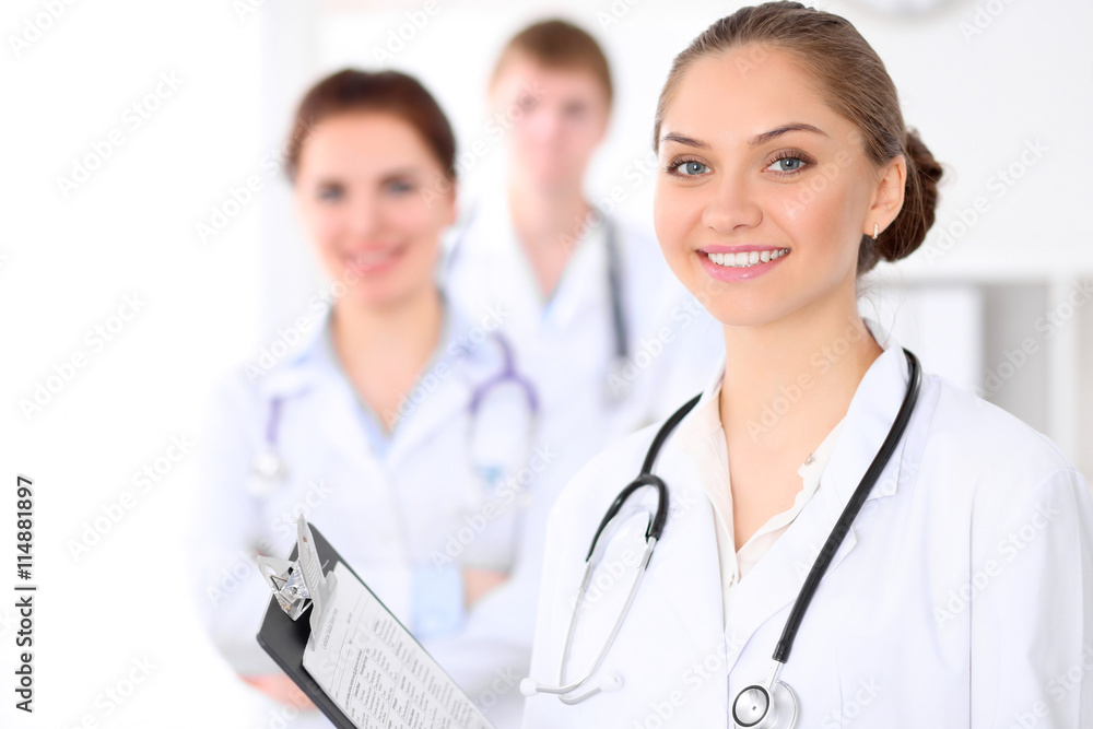 Happy doctor woman with medical staff at the hospital Happy doctor woman with medical staff at the hospital