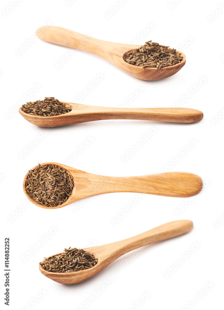 Wooden spoon full of cumin seeds Wooden spoon full of cumin seeds