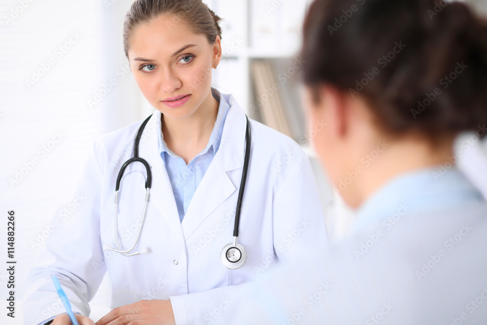 Doctor and patient sitting at the table. Very bad news concept. Doctor and patient sitting at the table. Very bad news concept.