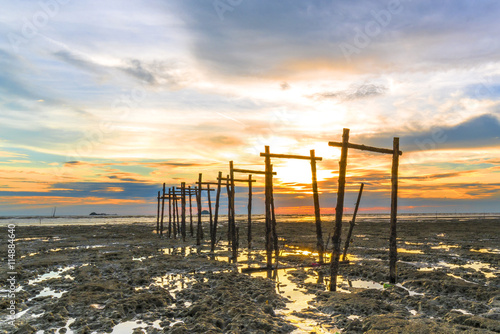 Wooden jetty with sunset background