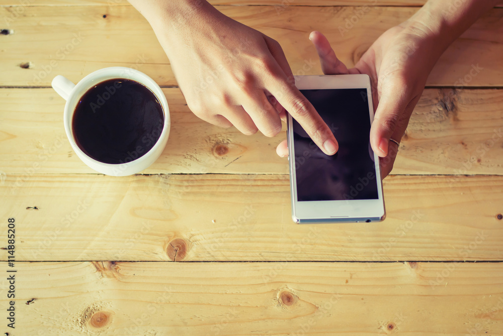 Close Up image of woman's hands holding mobile phone sitting in Close Up image of woman's hands holding mobile phone sitting in