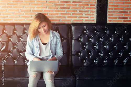 Beautiful young hipster woman using laptop, indoors