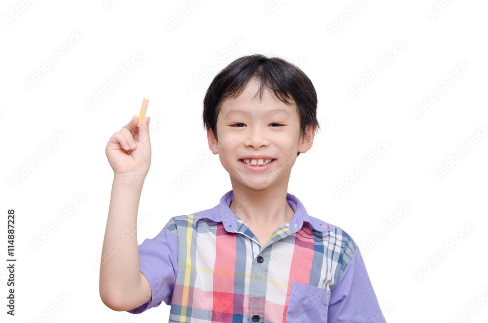 Young asian boy holding chalk and smiles over white Young asian boy holding chalk and smiles over white