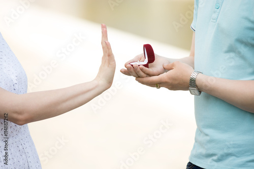 Fototapeta Close-up of hand of young woman turning down engagement proposal