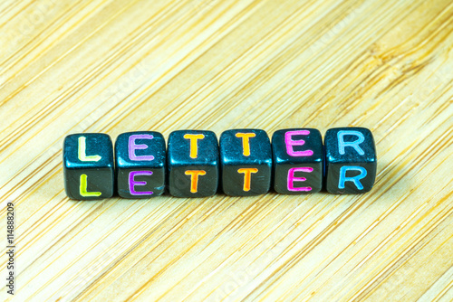 Colorful letter cube with bamboo texture surface. Educational co photo