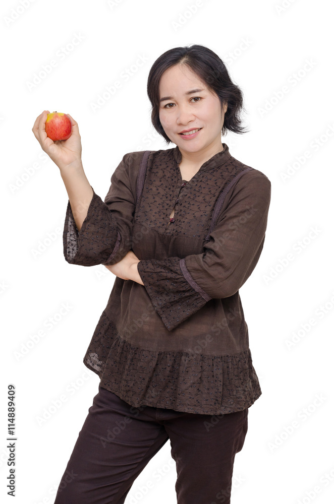 Middle aged asian woman holding an apple over white Middle aged asian woman holding an apple over white