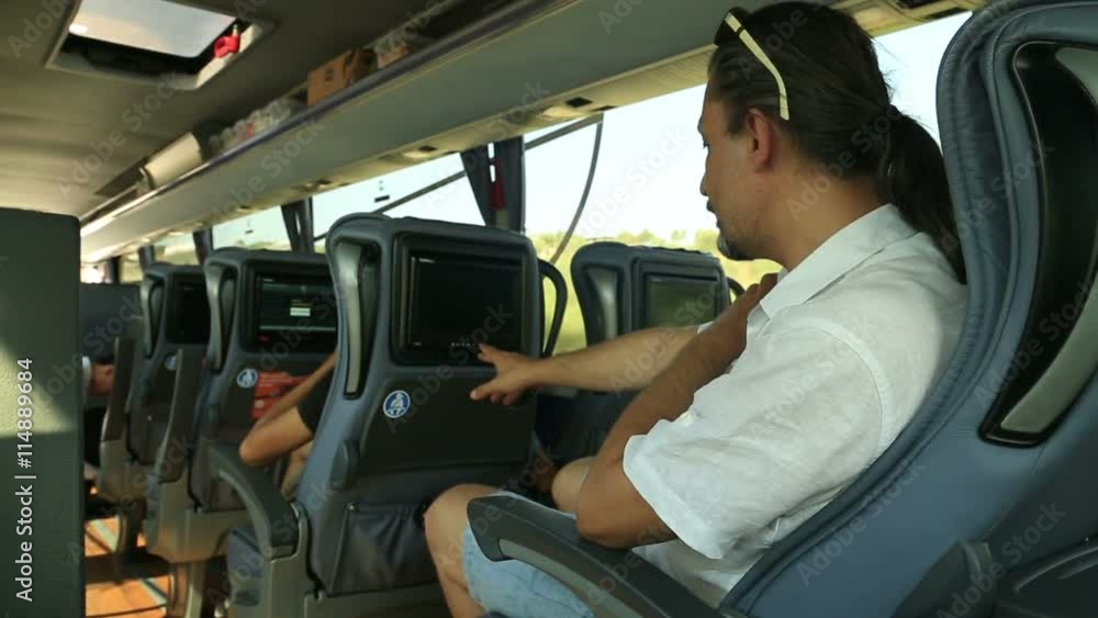 Man watching tv on the bus Man watching tv on the bus