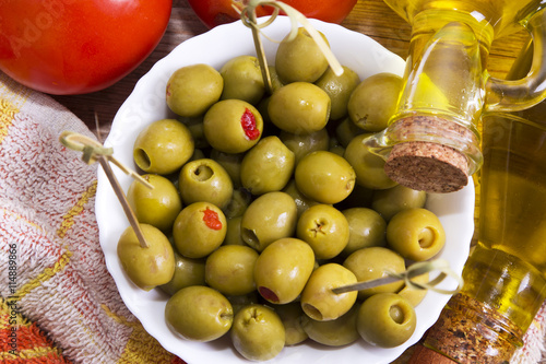 stuffed olives on wooden background photo