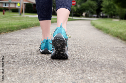 Runner/ woman  running on  a narrow road,  closeup on shoe/sneak