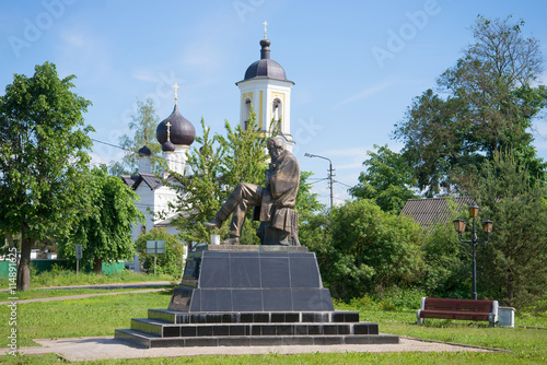 The monument to F. M. Dostoevsky at the St. Nicholas Church on a sunny june day. Staraya Russa, Russia photo