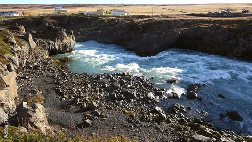 River flow with houses in background