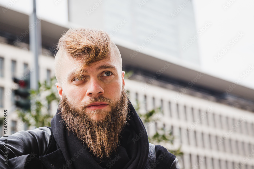 Stylish bearded man posing in the street Stylish bearded man posing in the street