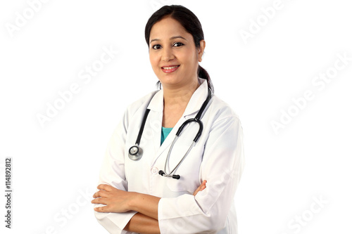 Happy young female doctor against white background
