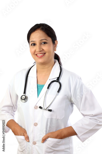 Happy young female doctor against white background