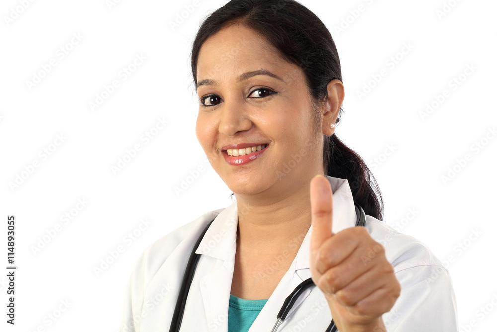 Young female doctor with thumbs up gesture Young female doctor with thumbs up gesture
