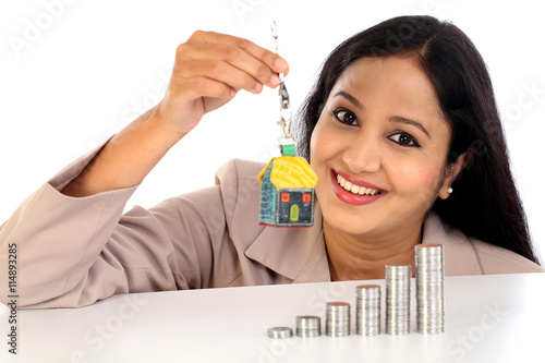 Young Business woman holding house shape key