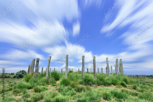 Long exposure shot of Heathland with ancient burial mounds and dramatic clouds, The Netherlands.