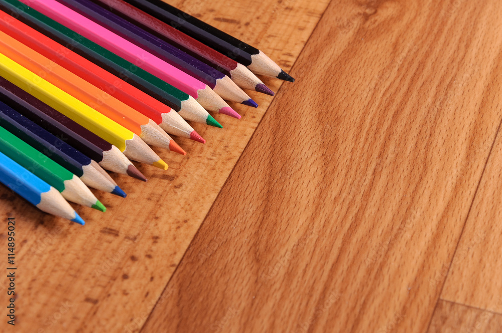 Colored pencils on a wooden board Colored pencils on a wooden board