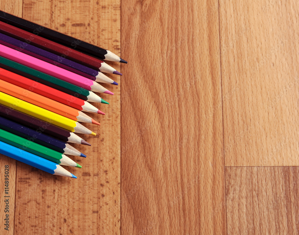 Colored pencils on a wooden board Colored pencils on a wooden board