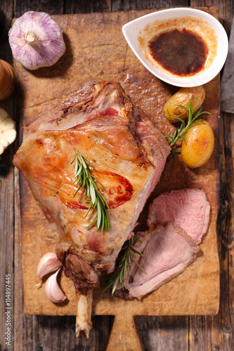 roasted lamb leg on wooden board