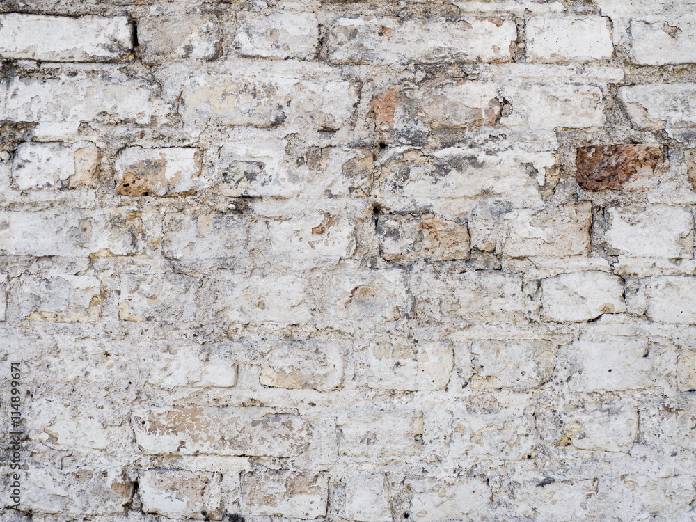 Old vintage damaged brick wall with plaster texture background