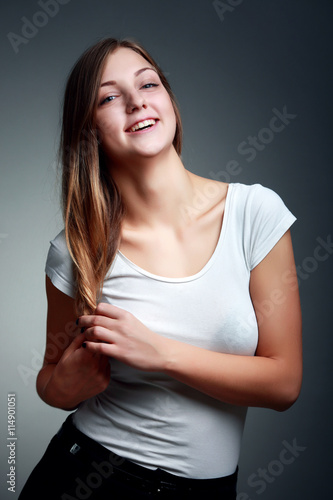 A Studio Portrait Of Smiling Teenage Girl