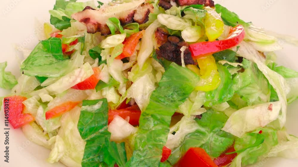 A foodie dressing a delicious octopus Mediterranean salad with olive oil
A foodie dressing a delicious octopus Mediterranean salad with olive oil