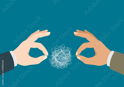 Hands trying to untangle the tangled thread