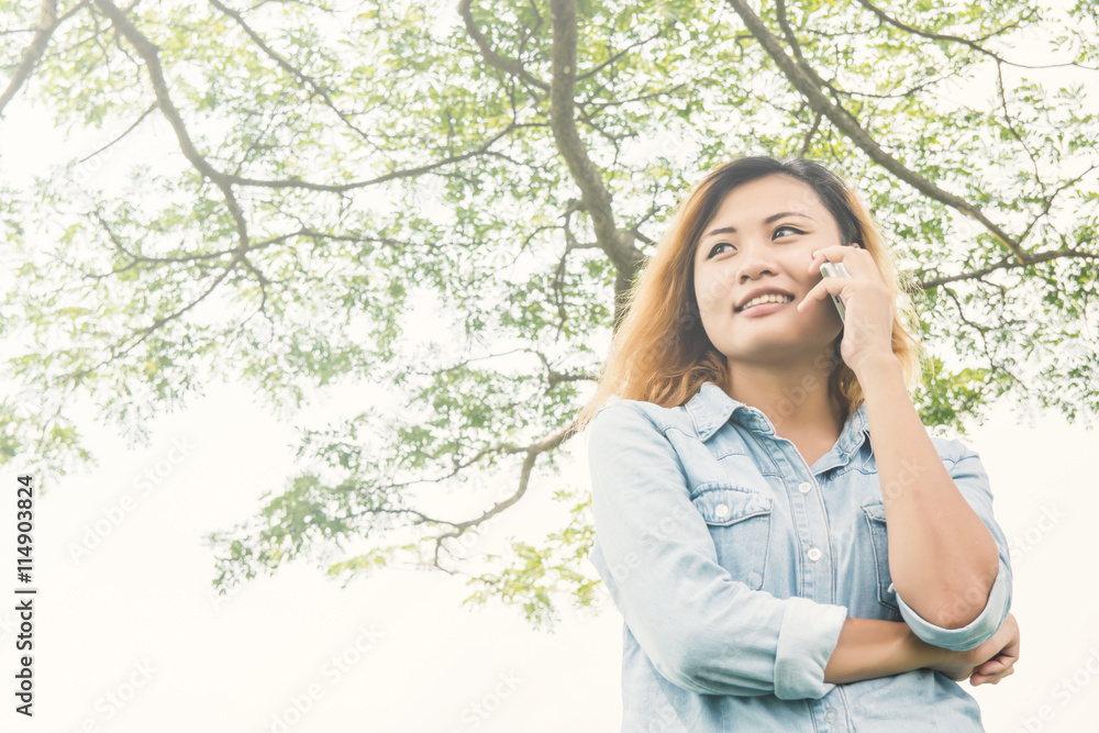 Young hipster woman talking in cell phone at the park. Young hipster woman talking in cell phone at the park.