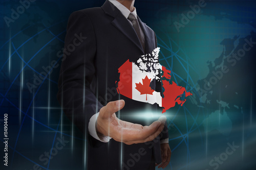 Businessman showing map of Canada on globe background