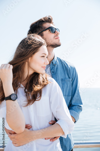 Portrait of a young couple standing together hugging