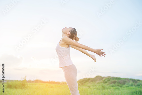 Healthy woman : Young woman spreading hands with joy the sun at