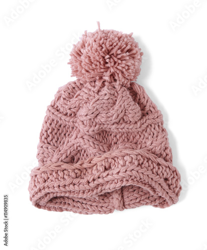 A cable knit winter beanie with pom pom, isolated on a white background