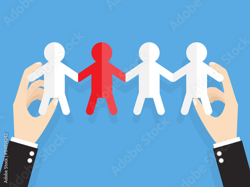 hands of businessman or manager holding people cut out of paper