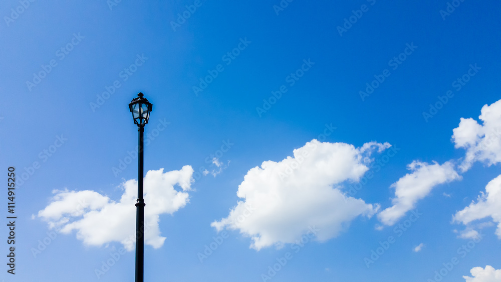 Post lamp with blue sky as background.