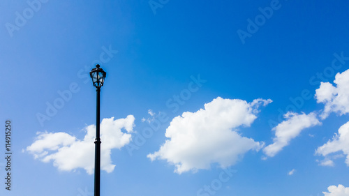 Post lamp with blue sky as background.