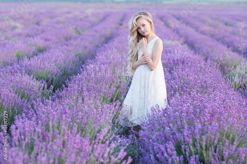 Beautiful small blond girl on the lavender field