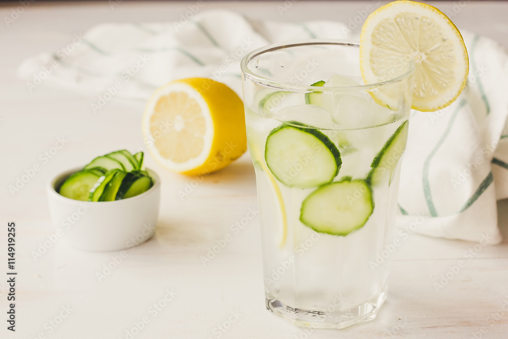 Glass with water, ice. cucumber and lemon