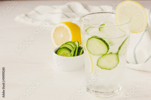 Cold drink with cucumber and lemon copy space