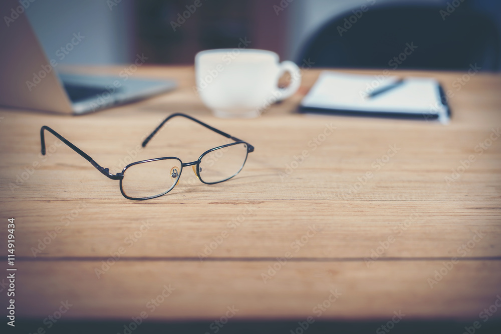 Glasses of Business workspace on wooden table. Glasses of Business workspace on wooden table.