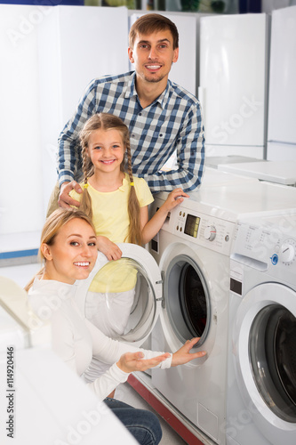 family selecting laundry washer