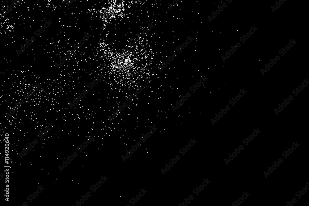 Abstract grainy texture isolated on black background. Silhouette of food flakes such as salt or almond or wheat flour spread on the flat surface or table. Top view. Dust, sand blow or bread crumbs.