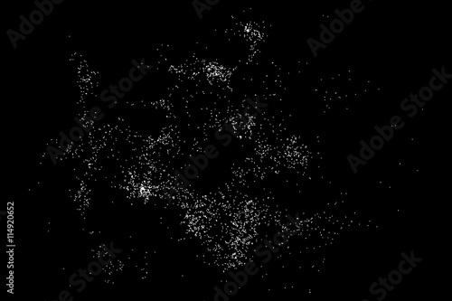 Abstract grainy texture isolated on black background. Silhouette of food flakes such as salt or almond or wheat flour spread on the flat surface or table. Top view. Dust, sand blow or bread crumbs.