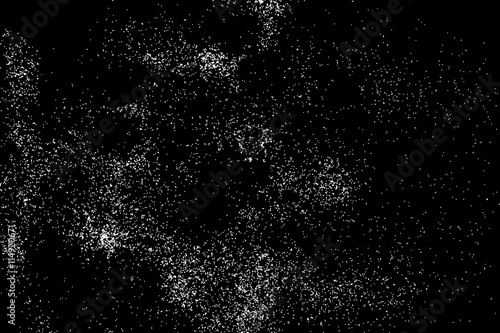 Abstract grainy texture isolated on black background. Silhouette of food flakes such as salt or almond or wheat flour spread on the flat surface or table. Top view. Dust, sand blow or bread crumbs.