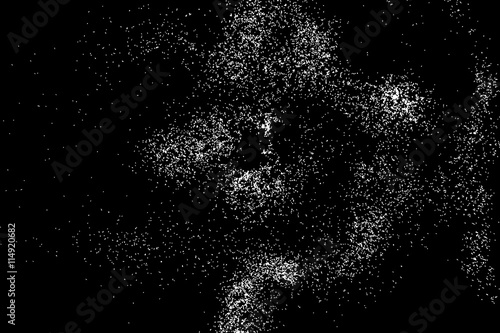 Abstract grainy texture isolated on black background. Silhouette of food flakes such as salt or almond or wheat flour spread on the flat surface or table. Top view. Dust, sand blow or bread crumbs.