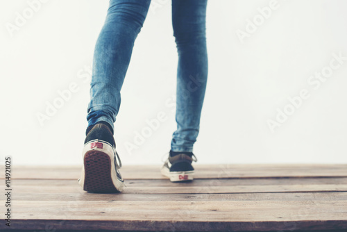 hipster cool woman feet with black sneakers, soft vintage toned