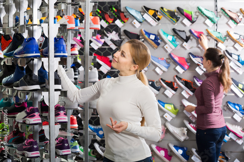 Girl choosing shoes in store