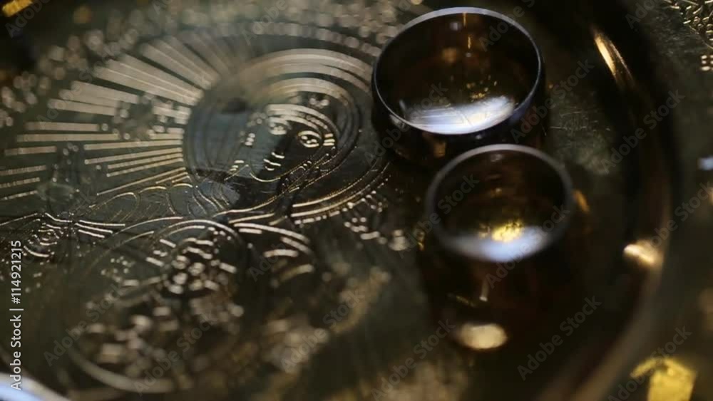 Close up of luxurious rings on gold plate in the church. Wedding ceremony Close up of luxurious rings on gold plate in the church. Wedding ceremony