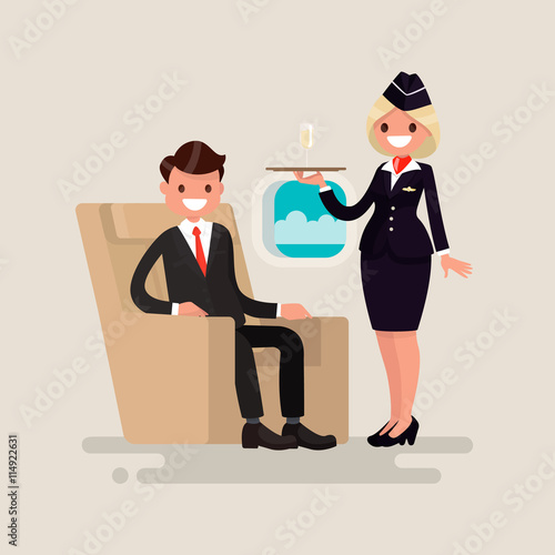 Business Class. The stewardess brings businessman the glass of c