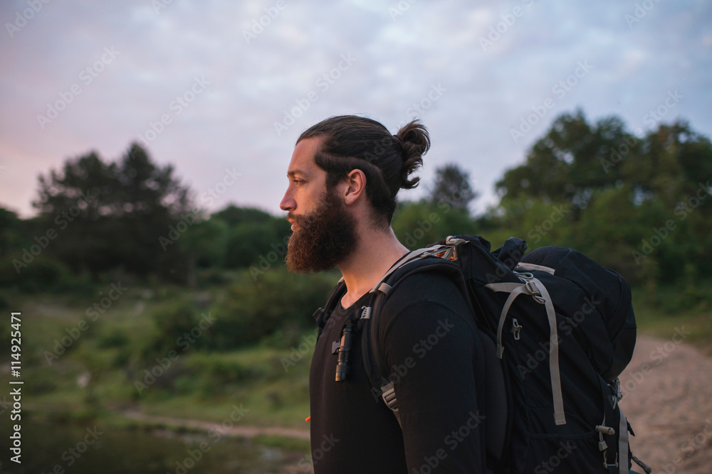 Man with beard and backpack in nature
